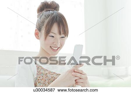 Young Woman with Mobile Phone View Large Photo Image Stock Photo - Young Woman with Mobile Phone. Fotosearch