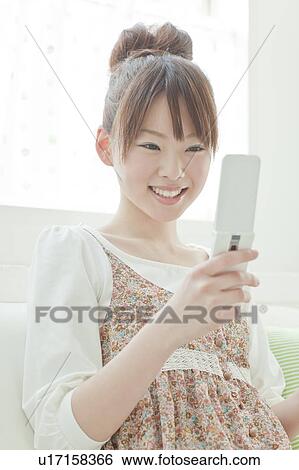 Stock Photograph - Young Woman with Mobile Phone. Fotosearch