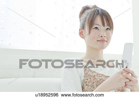 Stock Photograph - Young Woman with Mobile Phone. Fotosearch