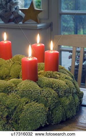 Stock Image - Advent wreath with burning candles. Fotosearch