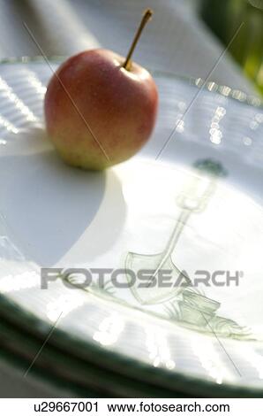 Stock Image - Apple on plate. Fotosearch