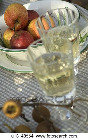 Picture - Apples in bowl and drinking glasses. Fotosearch