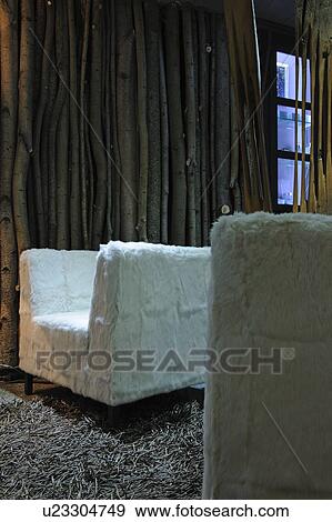 Stock Photo - Armchair with fur covering and fringed carpet. Fotosearch