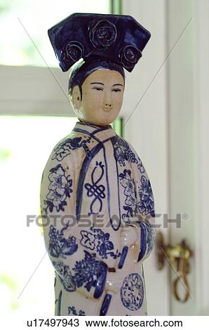 Asian figurine in front of window View Large Photo Image Stock Image - Asian figurine in front of window. Fotosearch