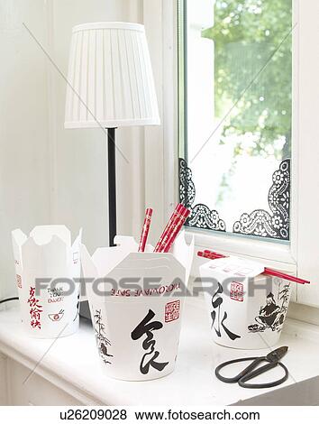 Stock Photo - Asian take away food boxes on windowsill. Fotosearch