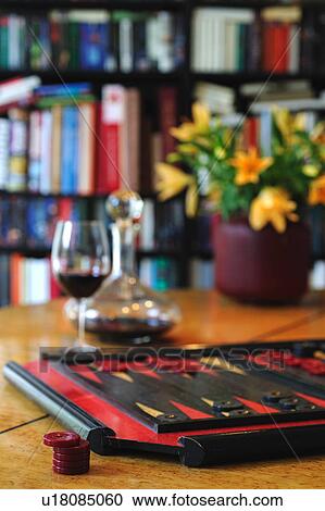 Stock Image - Backgammon set and glass of red wine. Fotosearch