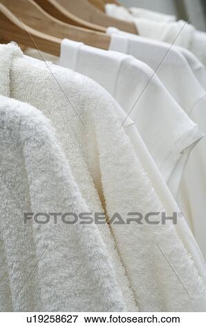 Bathrobes hanging on clothes hangers View Large Photo Image Stock Photo - Bathrobes hanging on clothes hangers. Fotosearch