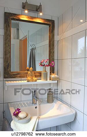Stock Image - Bathroom with mirror and statue of Buddha. Fotosearch