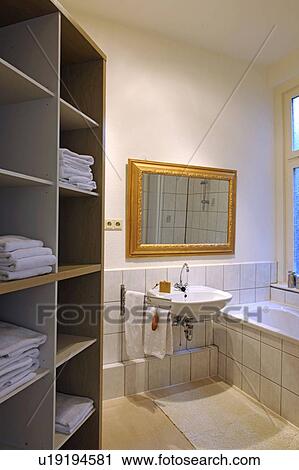 Stock Image - Bathroom with towels in shelf. Fotosearch