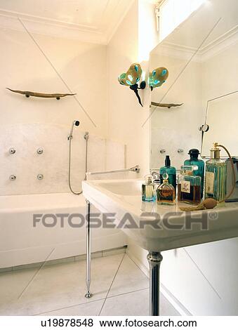 Bathroom with tub and several body care products View Large Photo Image Stock Photo - Bathroom with tub and several body care products. Fotosearch