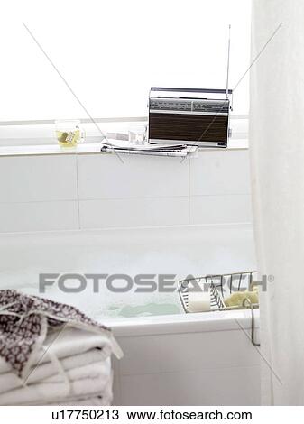 Stock Image - Bathtub and radio on windowsill. Fotosearch