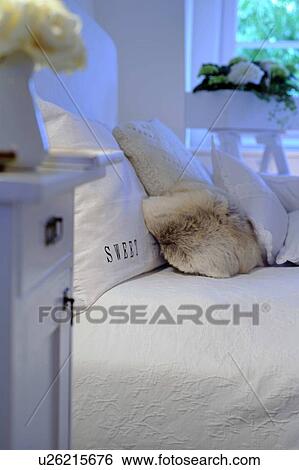 Stock Photograph - Bedroom with flowers and fur. Fotosearch