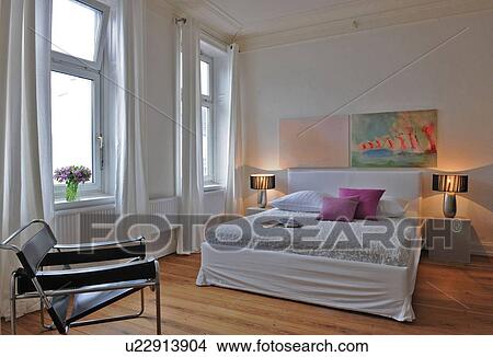 Bedroom with paintings on the wall View Large Photo Image Picture - Bedroom with paintings on the wall. Fotosearch