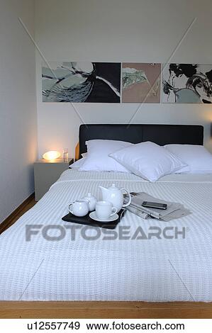 Stock Photo - Bedroom with tray on bed. Fotosearch