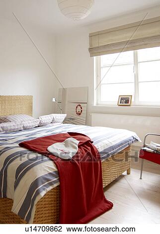 Stock Image - Bedroom with wicker bed. Fotosearch