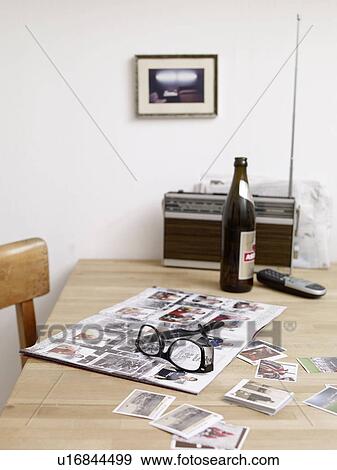 Beer bottle, eyeglasses and album with soccer collector cards on table View Large Photo Image Stock Photo - Beer bottle, eyeglasses and album with soccer collector cards on table. Fotosearch