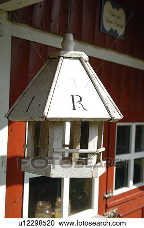 Stock Image - Birdhouse at red garden shed. Fotosearch