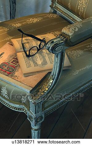 Book and eyeglasses on chair View Large Photo Image Stock Image - Book and eyeglasses on chair. Fotosearch