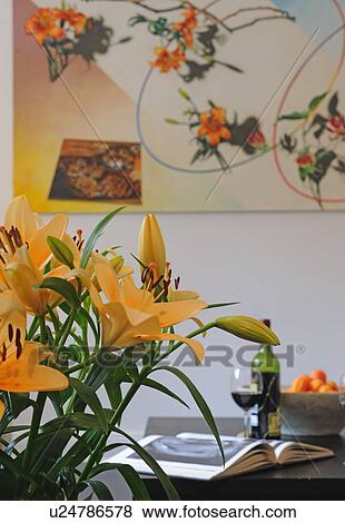 Stock Photo - Book, flower, red wine and fruit bowl on table. Fotosearch