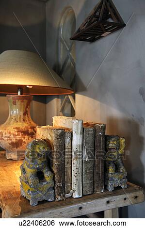 Books, bookends and lamp on wooden table View Large Photo Image Stock Photograph - Books, bookends and lamp on wooden table. Fotosearch