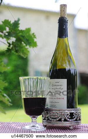 Stock Image - Bottle and glass of red wine. Fotosearch
