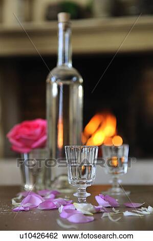Bottle, drinking glasses and petals View Large Photo Image Stock Image - Bottle, drinking glasses and petals. Fotosearch