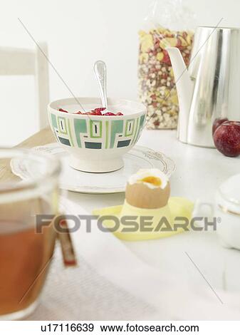 Stock Photo - Breakfast table with egg and muesli. Fotosearch