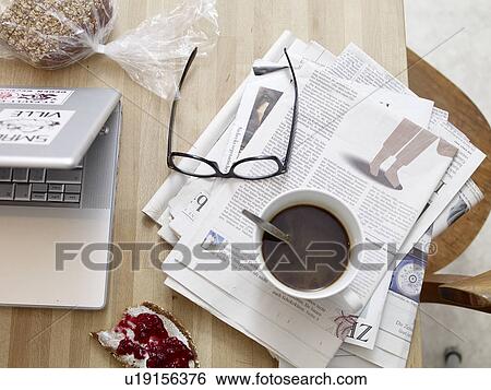 Breakfast table with newspaper and laptop View Large Photo Image Stock Photograph - Breakfast table with newspaper and laptop. Fotosearch