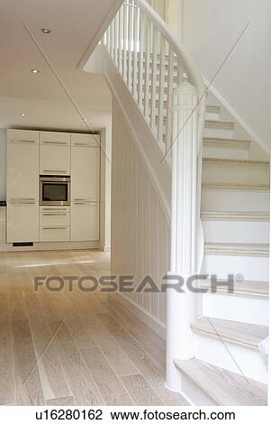 Stock Image - Bright floor with staircase and view into kitchen. Fotosearch