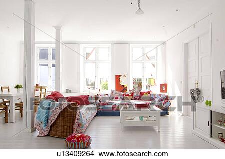 Picture - Bright living room with large couch dining area. Fotosearch