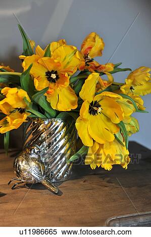 Stock Photography - Bunch of flowers and bird figurine. Fotosearch