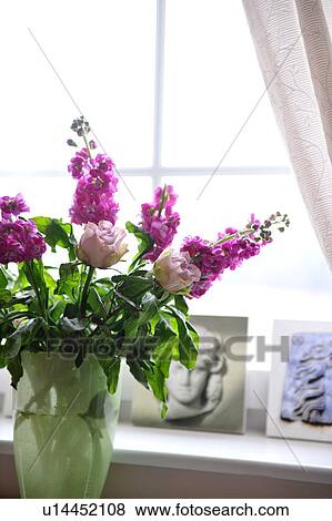Stock Photo - Bunch of flowers at the window. Fotosearch