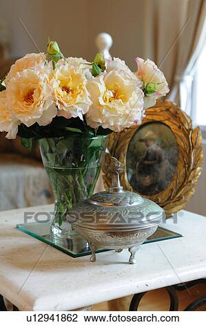 Bunch of flowers, bowl and painting on table View Large Photo Image Stock Image - Bunch of flowers, bowl and painting on table. Fotosearch