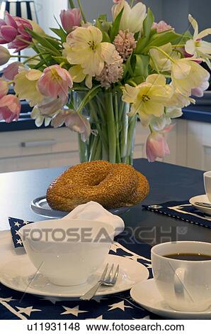 Stock Photo - Bunch of flowers on breakfast table. Fotosearch