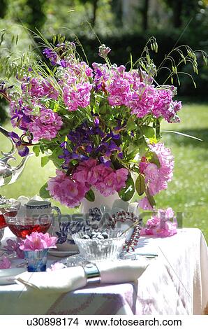Picture - Bunch of flowers on garden table. Fotosearch