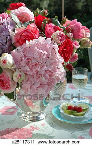 Stock Image - Bunch of flowers on garden table. Fotosearch