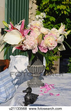 Stock Photo - Bunch of flowers on garden table. Fotosearch