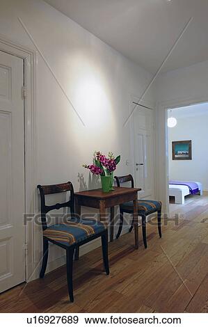 Bunch of flowers, table and chairs on corridor View Large Photo Image Stock Photo - Bunch of flowers, table and chairs on corridor. Fotosearch