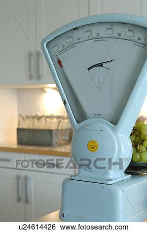 Stock Photograph - Bunch of grapes on scales. Fotosearch