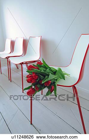 Bunch of red tulips on chair View Large Photo Image Stock Photograph - Bunch of red tulips on chair. Fotosearch