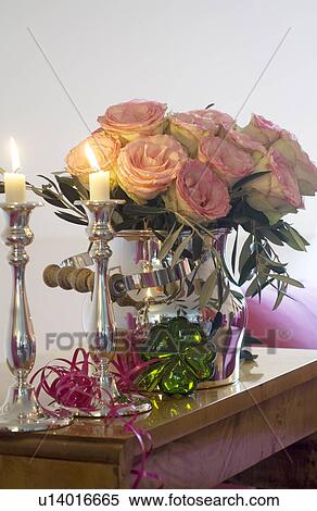 Stock Photography - Bunch of roses and burning candles. Fotosearch