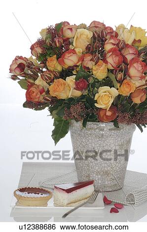 Stock Photograph - Bunch of roses and piece of cake. Fotosearch