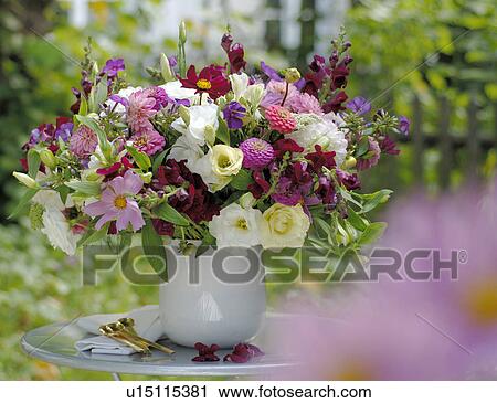 Stock Image - Bunch of summer flowers on garden table. Fotosearch