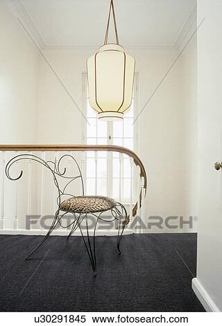Stock Photography - Chair and ceiling lamp upstairs. Fotosearch
