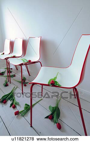 Chairs and scattered red tulips View Large Photo Image Stock Photo - Chairs and scattered red tulips. Fotosearch