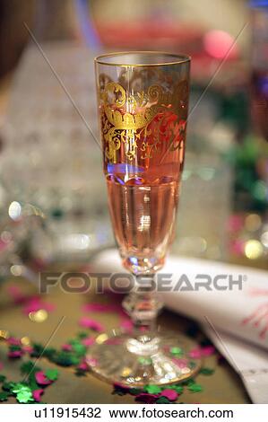 Champagne glass and confetti View Large Photo Image Stock Image - Champagne glass and confetti. Fotosearch