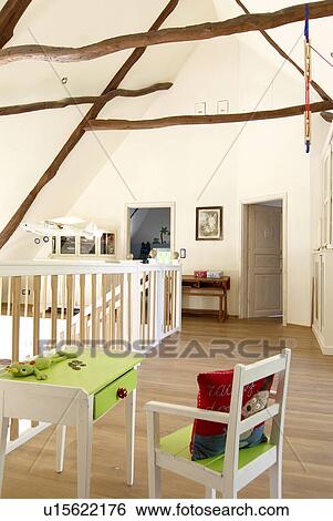 Stock Photograph - Childrens chair and table on upper floor. Fotosearch