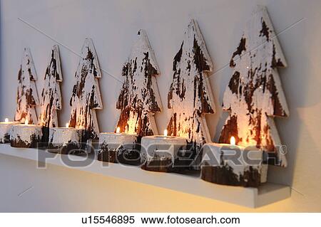 Stock Photography - Christmas decoration with burning candles on ledge. Fotosearch
