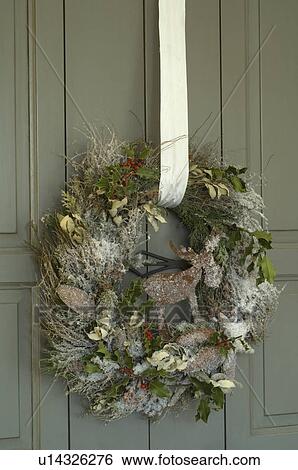Christmas wreath hanging at front door View Large Photo Image Stock Photograph - Christmas wreath hanging at front door. Fotosearch