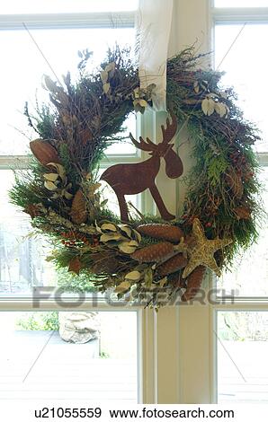 Christmas wreath hanging at window View Large Photo Image Stock Photo - Christmas wreath hanging at window. Fotosearch